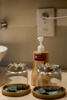 a bottle of mouthwash sitting on top of a counter at Fourteen Roses Boutique Hotel, Kuta in Legian
