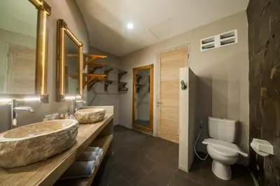 a bathroom with two sinks and a toilet at Luxury Villas Merci Resort 3BR Seminyak #1 in Seminyak
