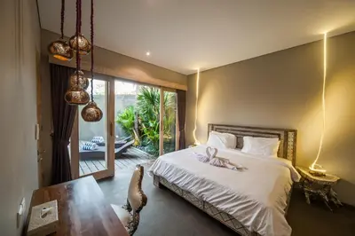 a bedroom with a bed with a flower on it at Luxury Villas Merci Resort 3BR Seminyak #1 in Seminyak