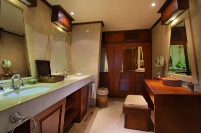 a bathroom with a sink and a large mirror at AlamKulkul Boutique Resort in Kuta