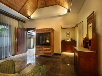 a living room with a tv and a entertainment center at AlamKulkul Boutique Resort in Kuta