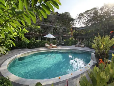 a swimming pool in the middle of a yard at AlamKulkul Boutique Resort in Kuta