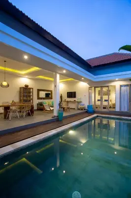 a villa with a swimming pool and a house at Villa Arif in Seminyak