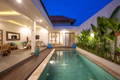 a swimming pool in the middle of a house at Villa Arif in Seminyak