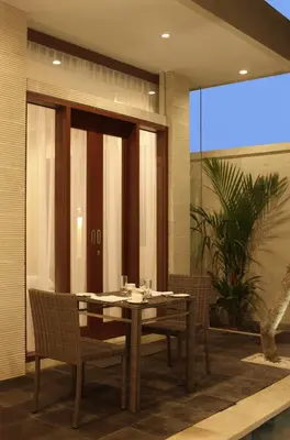a dining room with a table and chairs at Daluman Villas in Seminyak