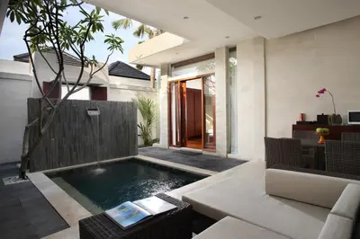 a swimming pool in the middle of a living room at Daluman Villas in Seminyak