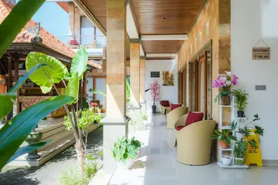 a lobby of a building with chairs and plants at Wayan House Seminyak in Seminyak