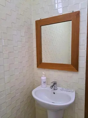 a bathroom with a sink and a mirror at Wayan House Seminyak in Seminyak