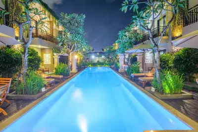 a swimming pool in a hotel at night at d'Penjor Seminyak in Seminyak