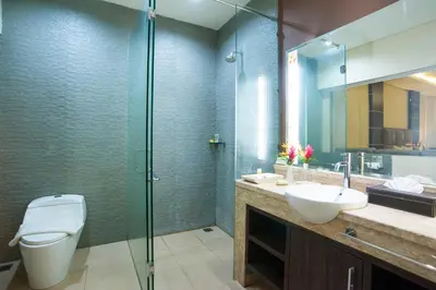 a bathroom with a toilet and a sink and a shower at d'Penjor Seminyak in Seminyak