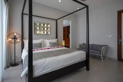 a bedroom with a black and white canopy bed at Villa SU'KHA UMALAS in Canggu