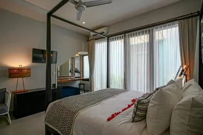 a bedroom with a large bed with a large window at Villa SU'KHA UMALAS in Canggu