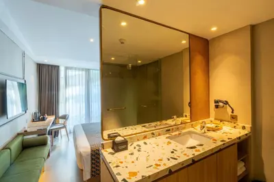 a bathroom with a sink and a large mirror at Episode Kuta Bali in Kuta