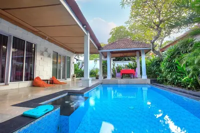 a swimming pool in a house with a gazebo at Lavender Villa & Spa in Kuta