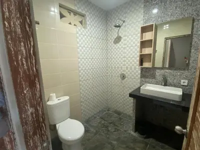 a bathroom with a toilet and a sink at Rusty Seminyak in Seminyak