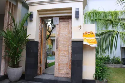 a door to a house with a towel on it at Rusty Seminyak in Seminyak