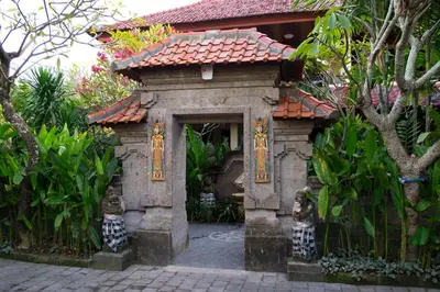 a small building with cats in front of it at Flamboyan Hotel in Kuta