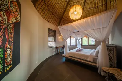 a bedroom with a bed with a canopy at Luxury Villas Merci Resort 3BR Seminyak #2 in Kuta