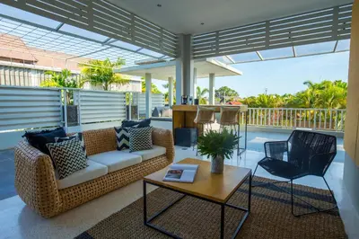 a living room with a couch and a table and chairs at Origin Seminyak in Seminyak