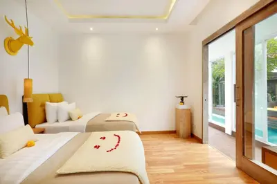 a bedroom with two beds and a window at La Mira Villa Seminyak by Ini Vie Hospitality in Seminyak