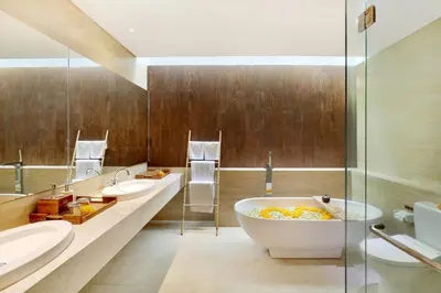 a bathroom with two sinks and a bath tub at La Mira Villa Seminyak by Ini Vie Hospitality in Seminyak