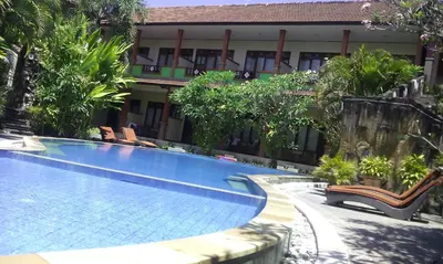 a large swimming pool in front of a building at Bali Diva Hotel Kuta in Kuta