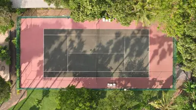 an overhead view of a tennis court with trees at The Jayakarta Bali Beach Resort in Legian