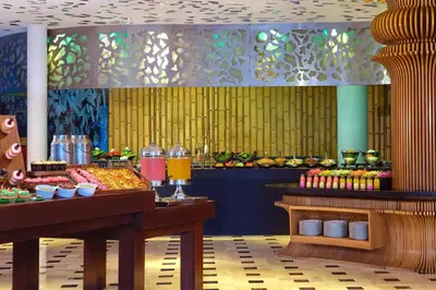 a restaurant with a buffet of food on display at Le Meridien Bali Jimbaran in Jimbaran