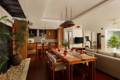 a living room with a table and a couch at Villa Camellia by Nakula in Jimbaran