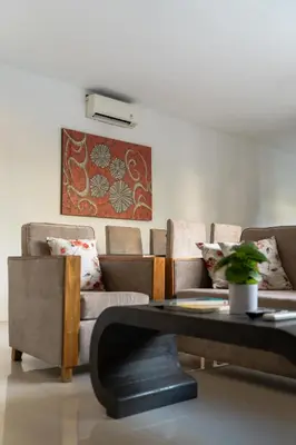 a living room with a couch and a table at Awila Villas Kuta by The Wina Resorts in Legian