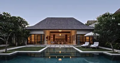 a villa with a swimming pool and a house at Nyaman Villas Seminyak in Seminyak