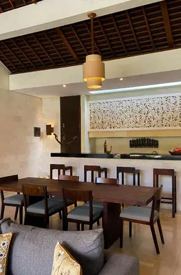 a dining room with a table and chairs at Nyaman Villas Seminyak in Seminyak