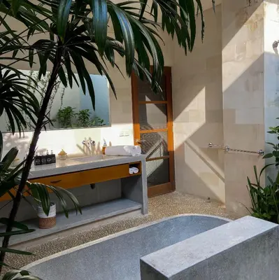 a bathroom with a sink and a mirror at Nyaman Villas Seminyak in Seminyak