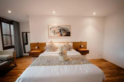 a hotel room with two beds and a couch at Luxury Villa Seminyak near beach and Potato Head in Seminyak