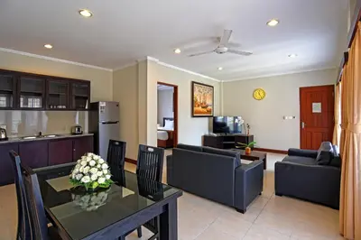 a living room with a couch and a table at Kuta Town House Apartments in Kuta