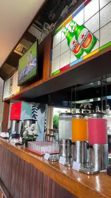 a bar with a counter top with drinks on it at Kuta Town House Apartments in Kuta