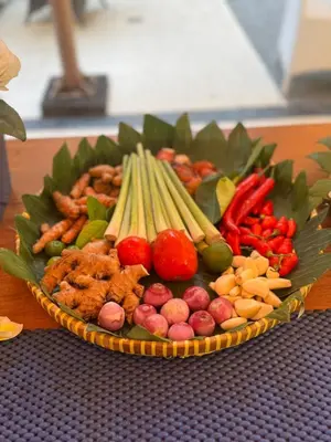 a plate of food with vegetables on a table at Kuta Town House Apartments in Kuta