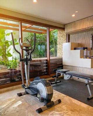a gym with a treadmill and a exercise bike at tanadewa Villas Nusa Dua Bali by Cross Collection in Nusa Dua