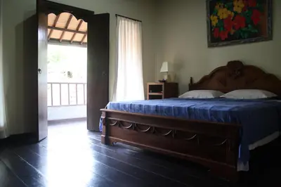 a bedroom with a bed with blue sheets and a window at De Puspa Residence Seminyak in Seminyak