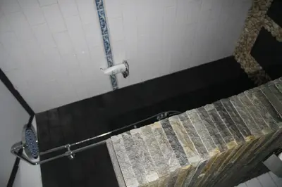 a shower in a bathroom with a shower curtain at De Puspa Residence Seminyak in Seminyak