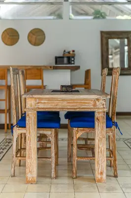 a wooden table with four chairs and a table with basketballs at Villa Laksmana Hideaway 2 - Surrounded by water- 2bd villa with fantastic pool! in Seminyak