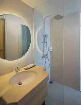 a bathroom with a sink and a shower at Solaris Hotel Kuta in Kuta
