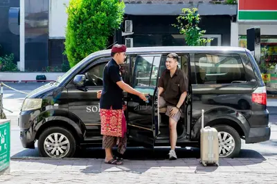 two people standing in the door of a van at Solaris Hotel Kuta in Kuta