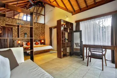 a bedroom with a bed and a desk in a room at Villa Esperanto Seminyak in Seminyak