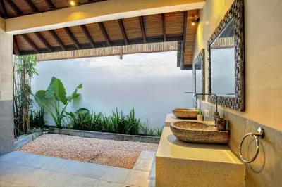 a bathroom with two sinks and a mirror at Villa Esperanto Seminyak in Seminyak