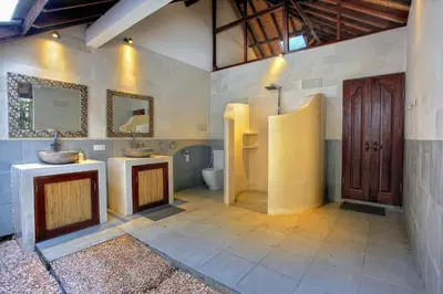 a bathroom with two sinks and a toilet at Villa Esperanto Seminyak in Seminyak