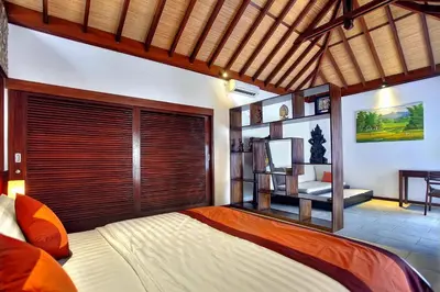 a bedroom with a large bed with a large window at Villa Esperanto Seminyak in Seminyak