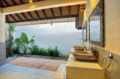 a bathroom with two sinks and a mirror at Villa Esperanto Seminyak in Seminyak