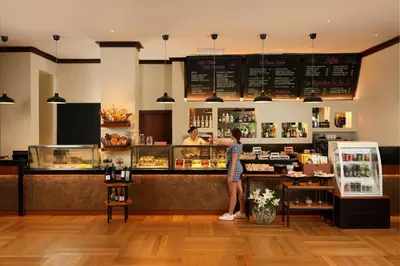 a woman standing at the counter of a restaurant at Padma Resort Legian in Legian