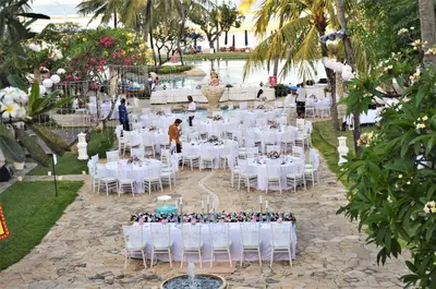 a wedding reception with white tables and chairs at Hotel Nikko Bali Benoa Beach in Nusa Dua